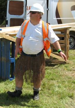 carl in grass scirt The roof fit perfectly and Carl let out a sigh of relief and did a little dance in thatched roof builders costume.